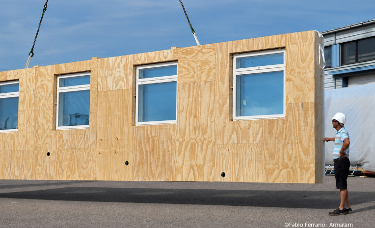 Prefabricated timber facade module with windows for off-site retrofit installation on existing buildings
