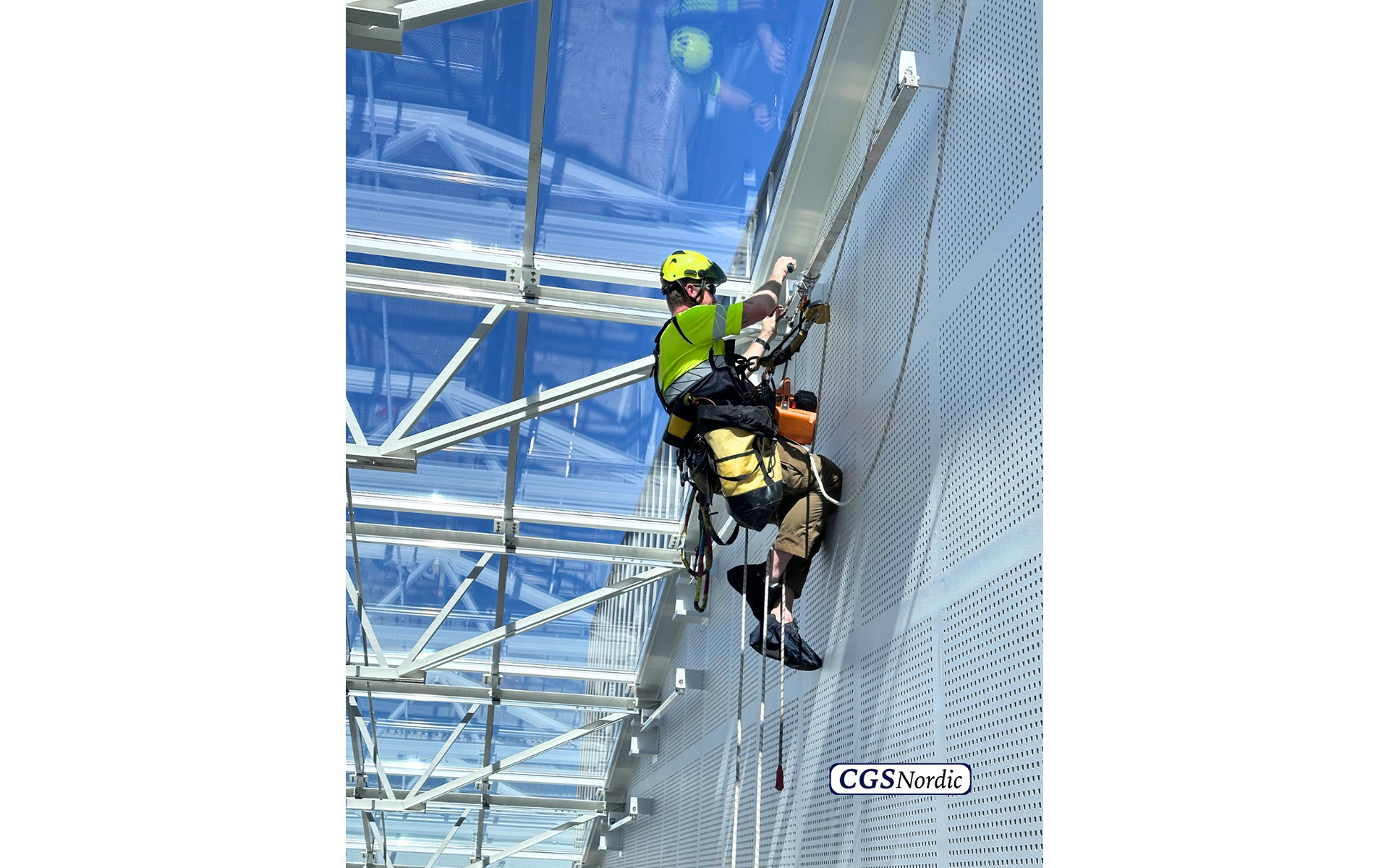 H-RAIL rigid rail system mounted on steel structure under glazed atrium roof, installed by CGS Nordic to enable rope access for safe maintenance of atriums and glazed surfaces.