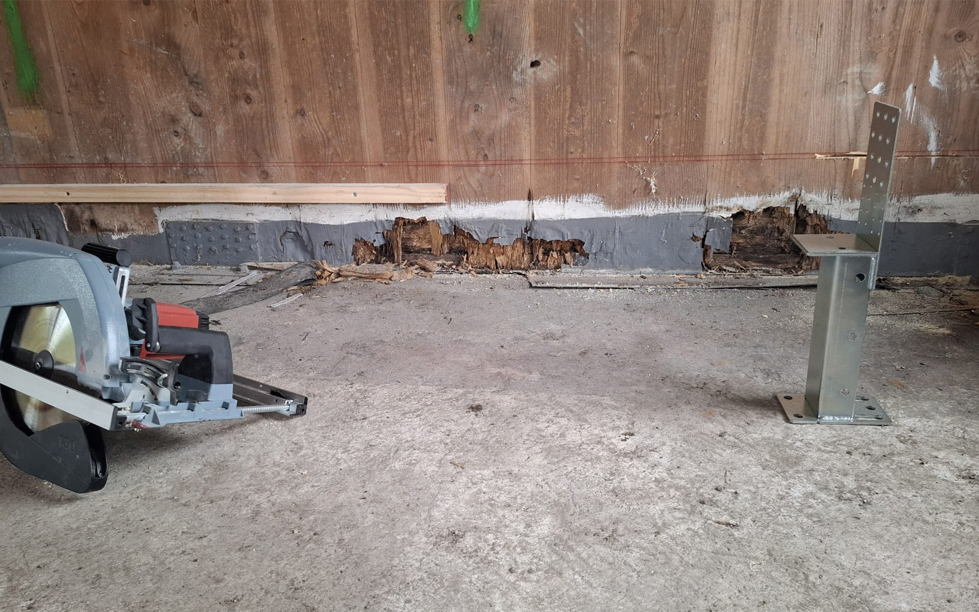 Timber building retrofit with decayed base detail and lifting system for X-LAM structural repair