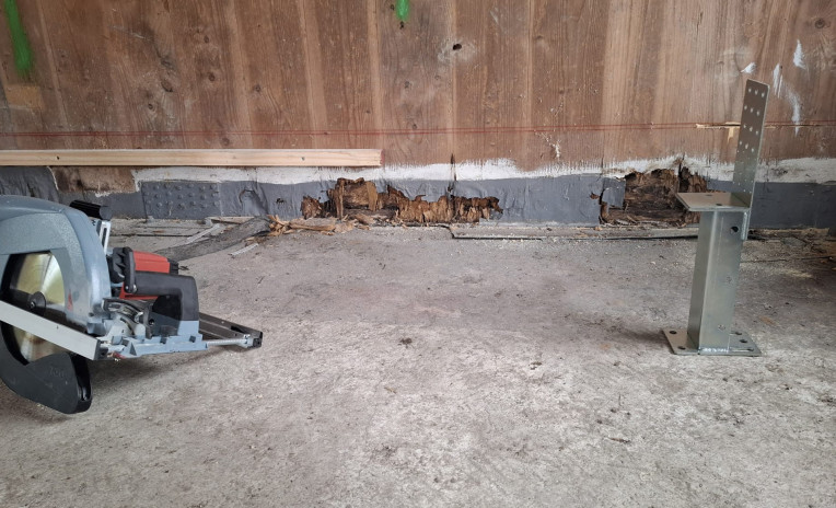 Timber building retrofit with decayed base detail and lifting system for X-LAM structural repair