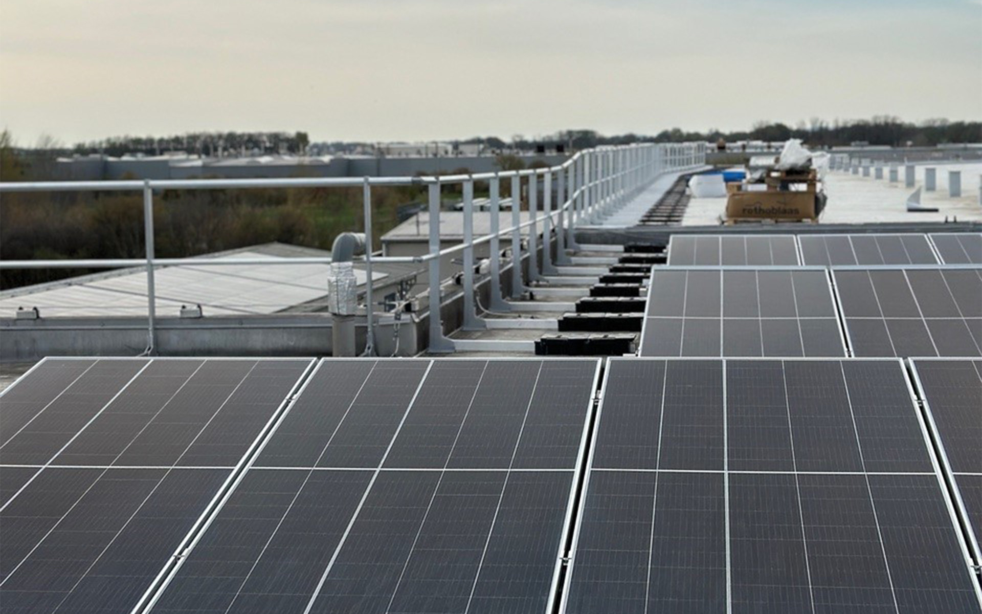 Rooftop solar panel installation with safety guardrails and secured access system.
